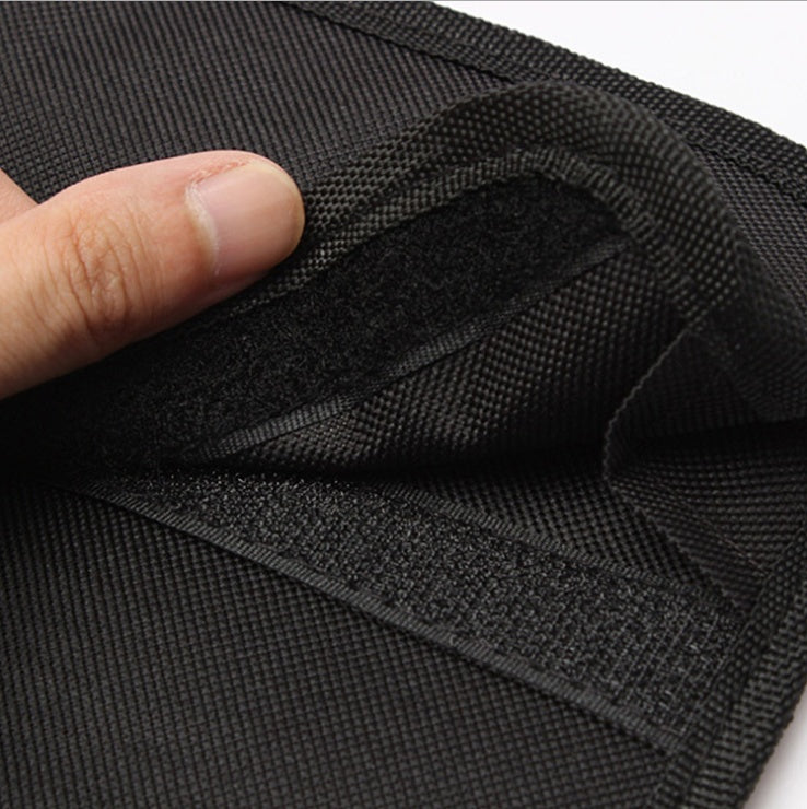 Close-up of black fabric with a hand touching it