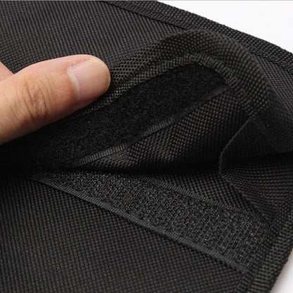 Close-up of black fabric with a hand touching it